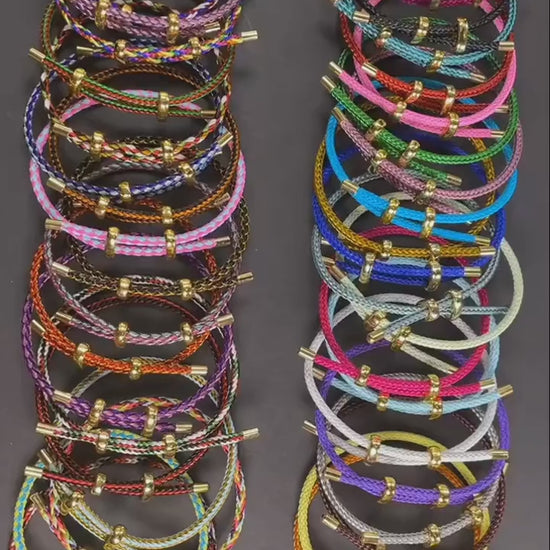 Product video—adjustable multicolor rope bracelets with stainless steel wire and gold-tone ends, stacked display on a neutral background — OmniVivo