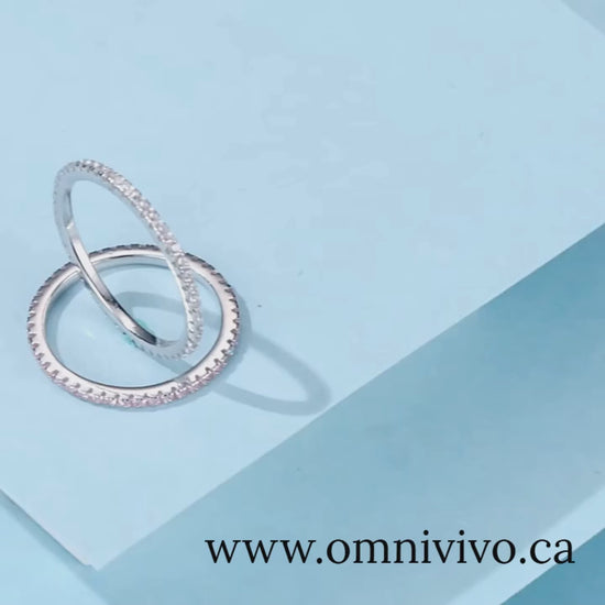 Stackable 925 sterling silver rings with full pavé stones, slim polished bands on blue backdrop — OmniVivo