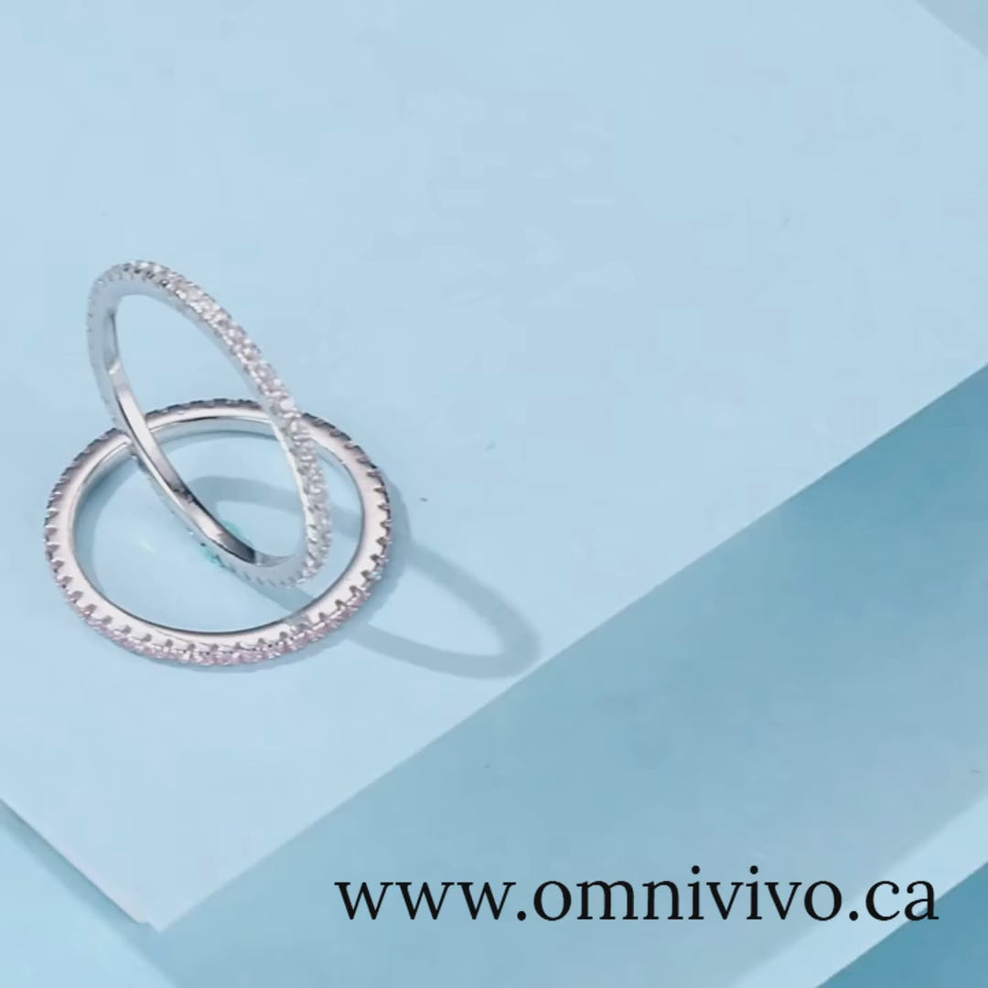 Stackable 925 sterling silver rings with full pavé stones, slim polished bands on blue backdrop — OmniVivo