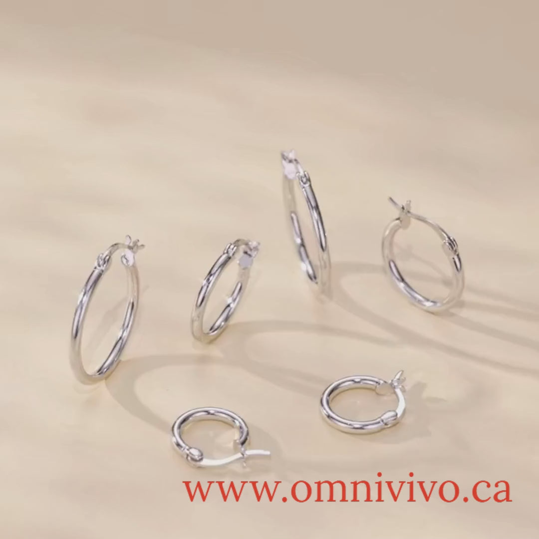 Product video showcasing glossy tube 925 sterling silver hoop earrings, 14K white gold plated, on a neutral background — OmniVivo