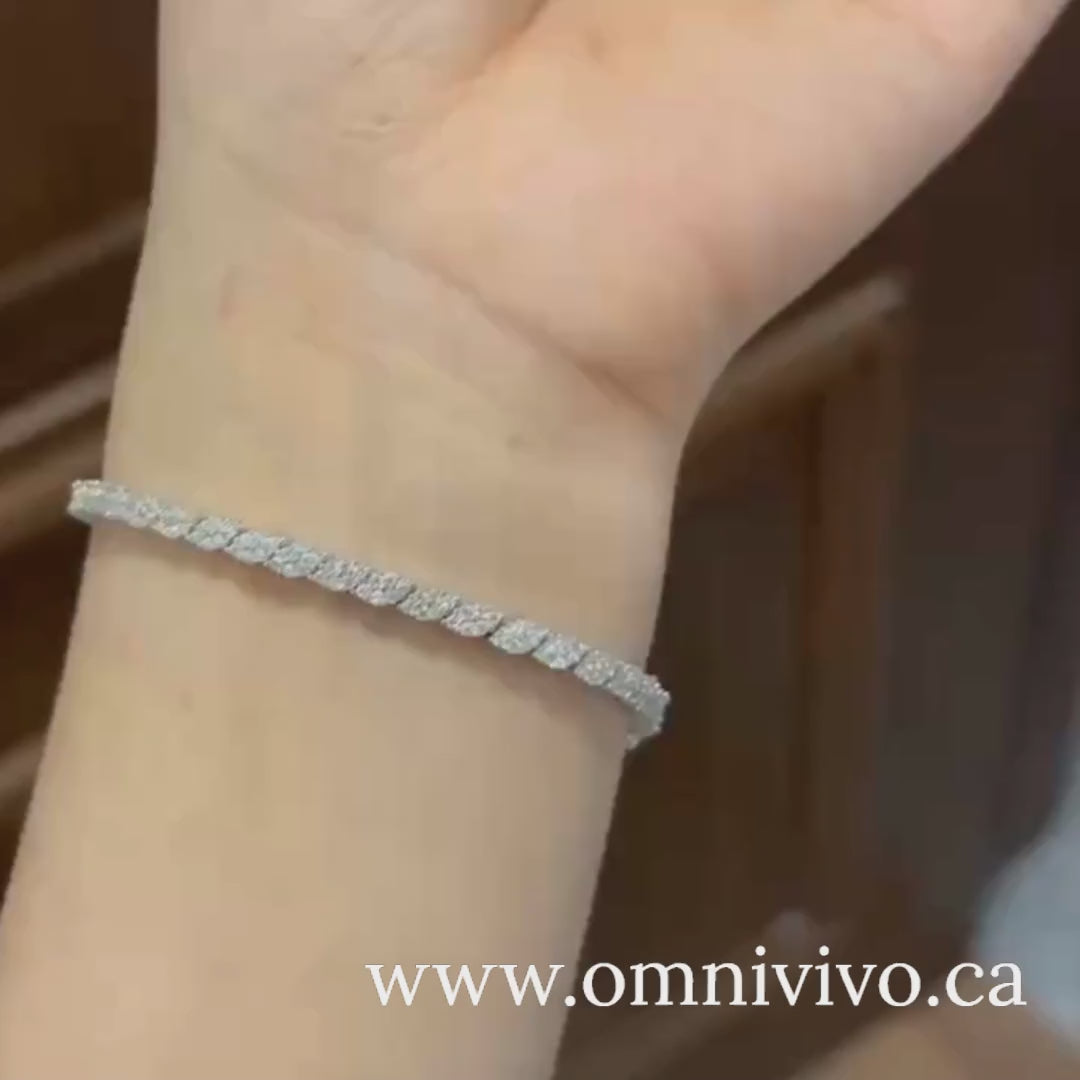 On-wrist lifestyle video of moissanite tennis bracelet in 925 sterling silver with D color VVS1 1.2 mm stones, shown in natural indoor lighting — OmniVivo