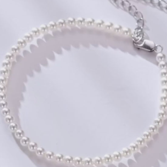 Vertical video of a shell pearl beaded bracelet in 925 sterling silver with adjustable extender, soft light close-ups — OmniVivo.