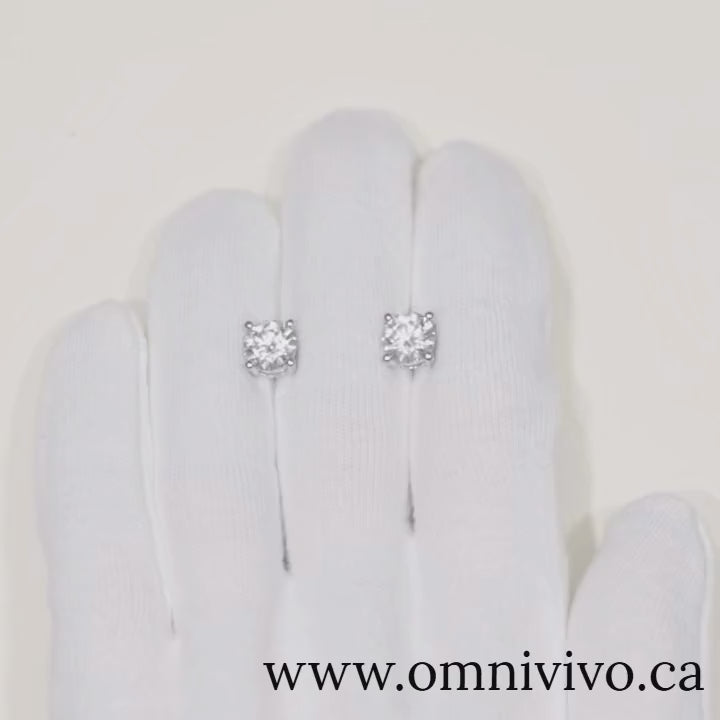 Close-up video of 0.5–1 ct D-Color VVS1 moissanite stud earrings in 925 sterling silver with screw backs, white-gold finish, shown on white glove — OmniVivo