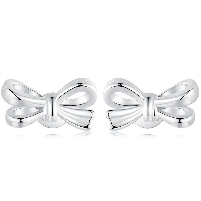 Sterling silver bow stud earrings with double-loop ribbon design on white background.