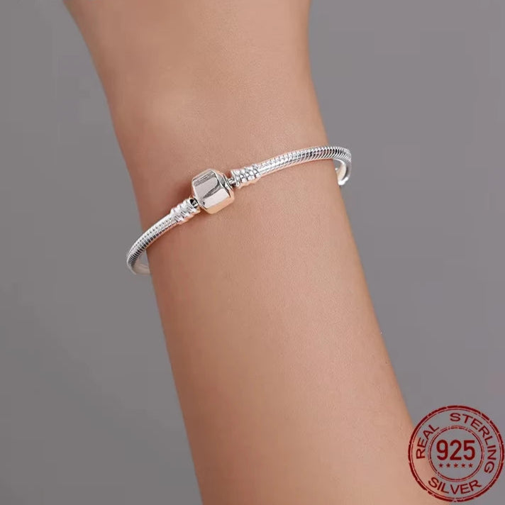 Alt (EN): 925 sterling silver 3 mm snake chain bracelet with barrel clasp shown on wrist, S925 stamp, gray background